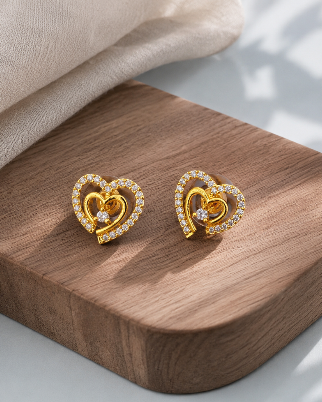 Golden CZ heart stud earrings for women